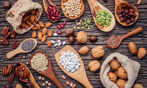 Selection of nuts, grains and pulses on a wooden board