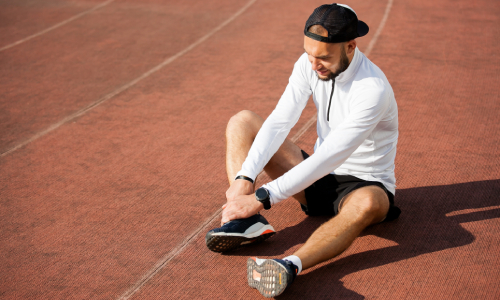 Man holding his ankle in pain