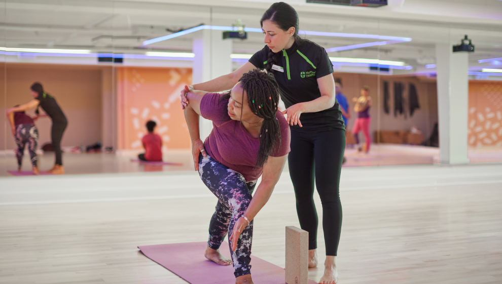 A woman stretching her joints with help from her physiotherapist