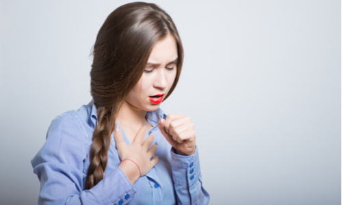 Woman coughing and clutching chest