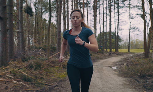 Woman running in woods