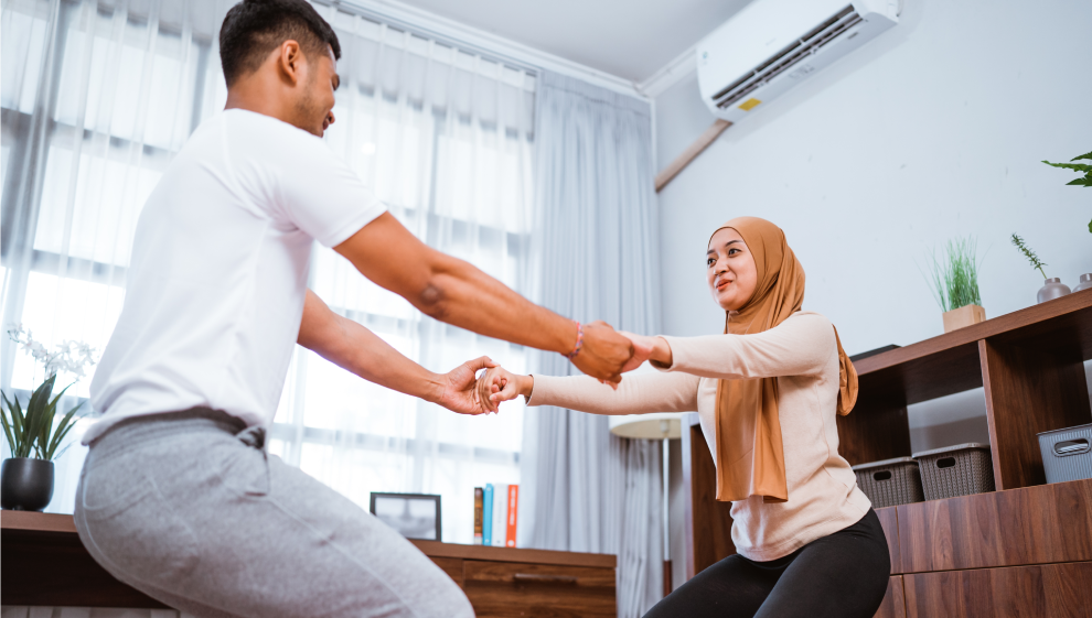 Muslim couple performing a partner squat