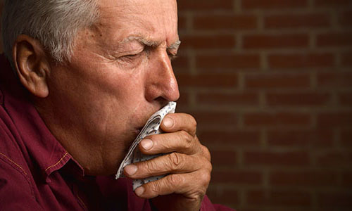 Senior man coughing