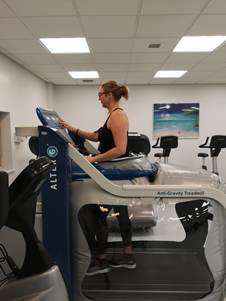 Sarah out of a wheelchair using the AlterG rehabilitation treadmill at Nuffield Health Leeds Hospital