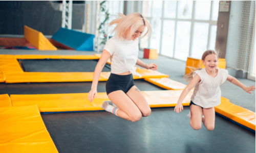 family fitness - Mum and daughter bouncing on trampoline