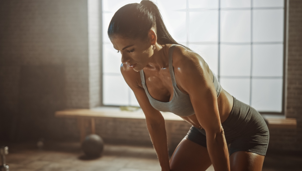 Fit Young Woman Sweating during a Gym Workout with Rings Stock