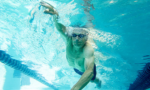 Senior man swimming