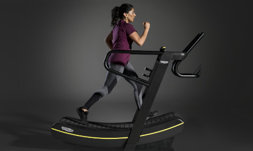 TECHNOGYM SKILLMILL - woman walking on gym equipment