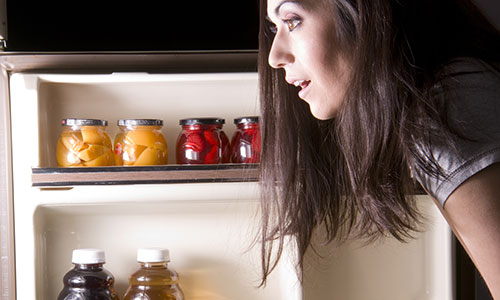 Woman raiding fridge in the middle of the night