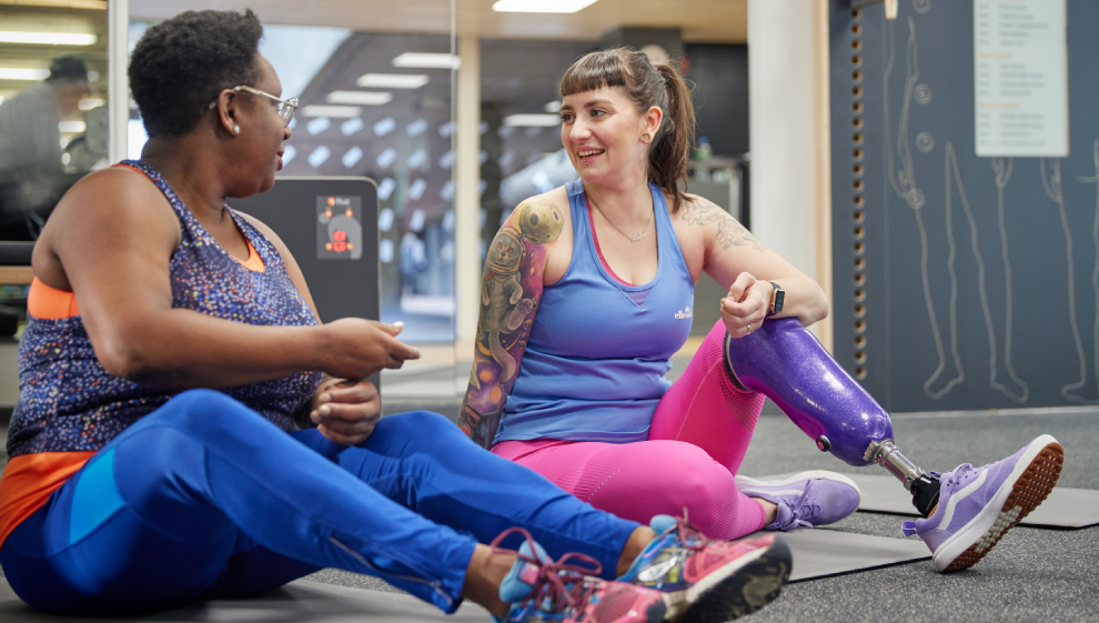 Two women chatting in the gym after a workout