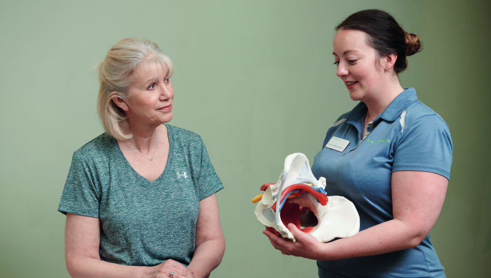 An elderly woman seeking pelvic advice from a physiotherapist