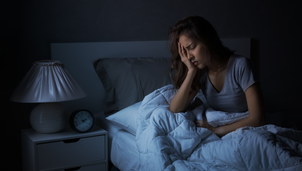 A woman suffering from insomnia struggles to sleep at night 