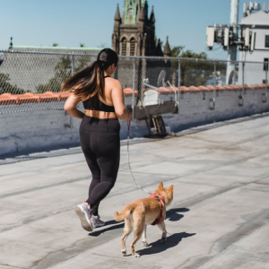 A woman on a run with her pet dog
