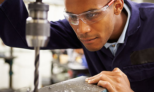 Working man wearing safety glasses