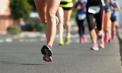 Legs of runners in a road marathon