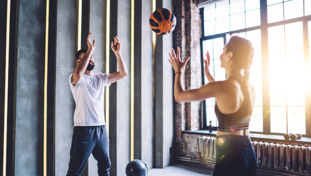 a couple performs a ball pass and shuffle exercise