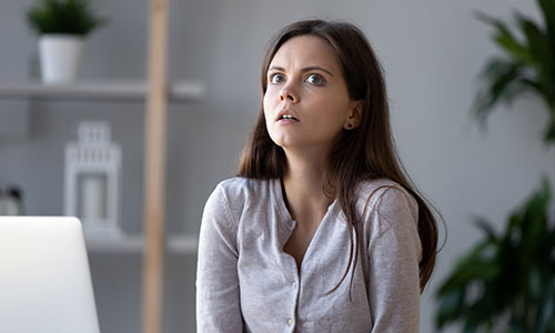 Business woman in office looks like she's having a crisis of confidence