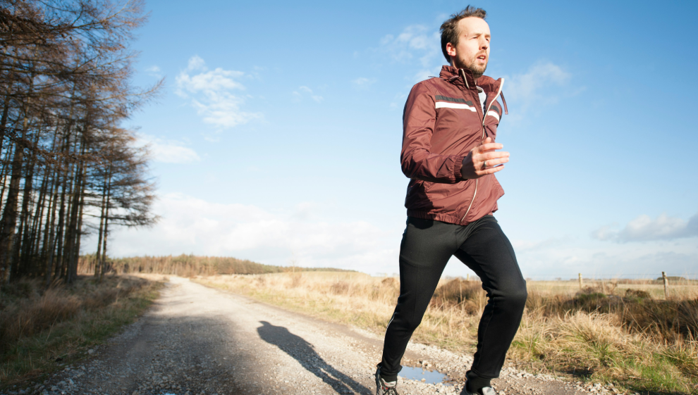 A man goes on a jog during a cold winters day