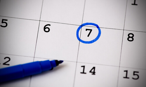 A date circled in blue pen on a calendar