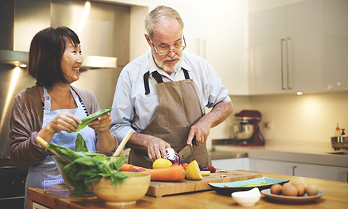 Cooking mindfully - older couple cooking in kitchen