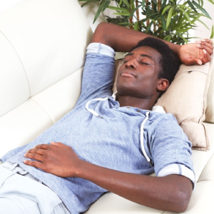 A man laying on his sofa relaxed