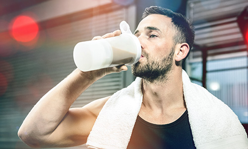 Fitness nutrition - man drinking protein shake full of macros