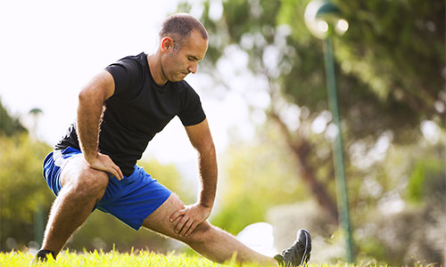 Man stretching in a park