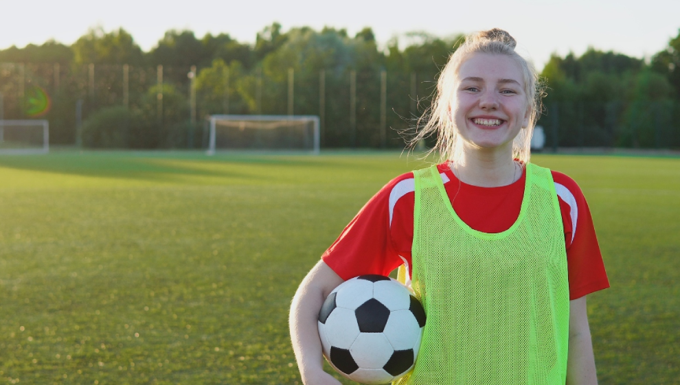 A teenage girl playing football