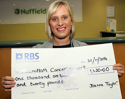 Joanne with funds raised for cancer charity