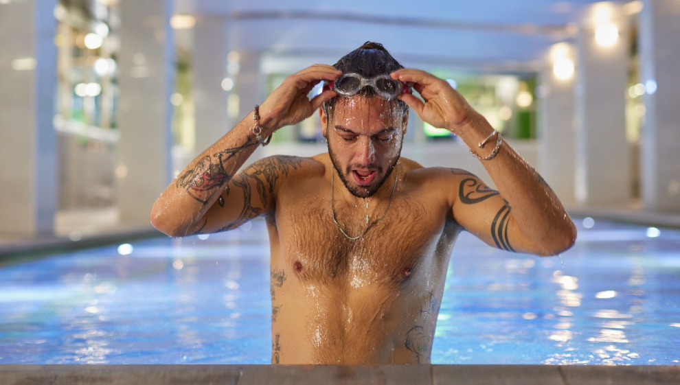 A man taking a breather after swimming a few laps