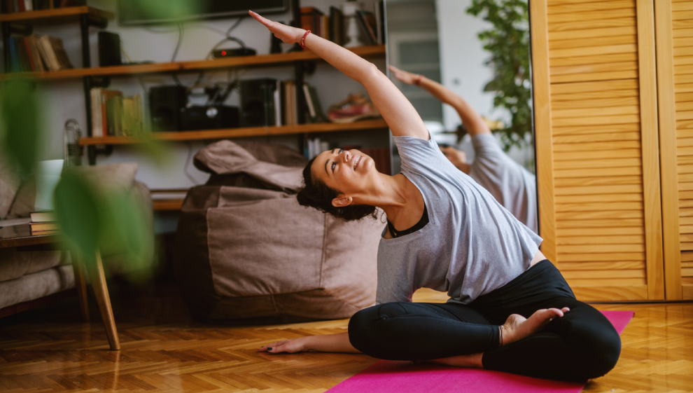 A woman performs evening yoga to prepare her for a deep sleep 