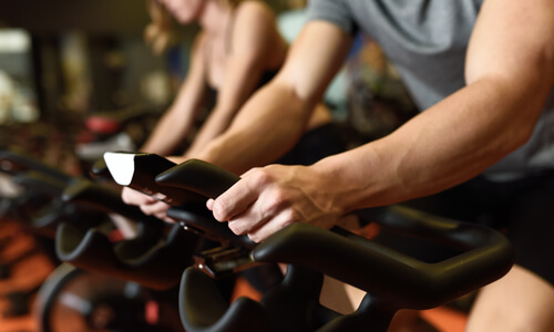 Close up of man cycling intensely indoors