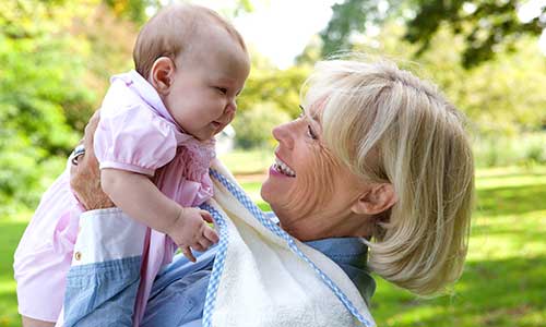 Grandmother and new baby in the park