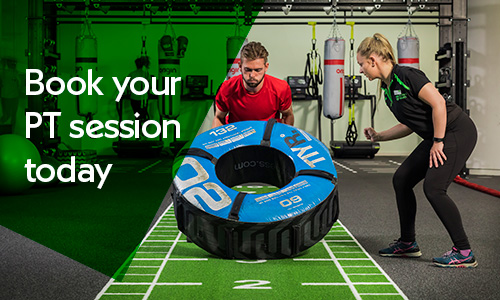 Personal Training - man lifting tyre with instruction from female PT