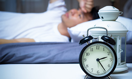 Man struggling to get to sleep