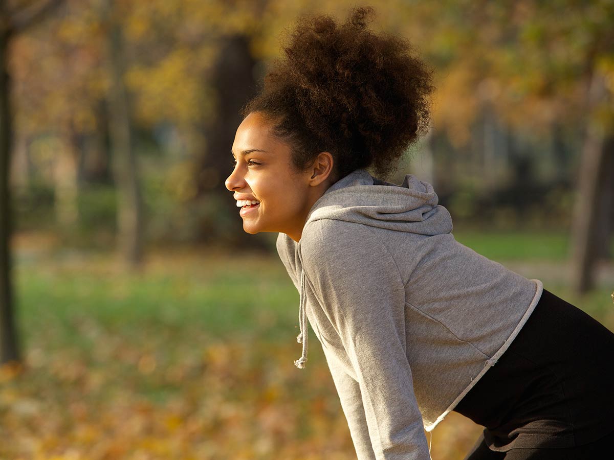 Woman smiling in park after exercise