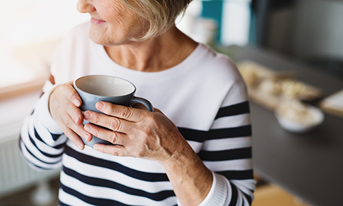 Older woman with cup of coffee